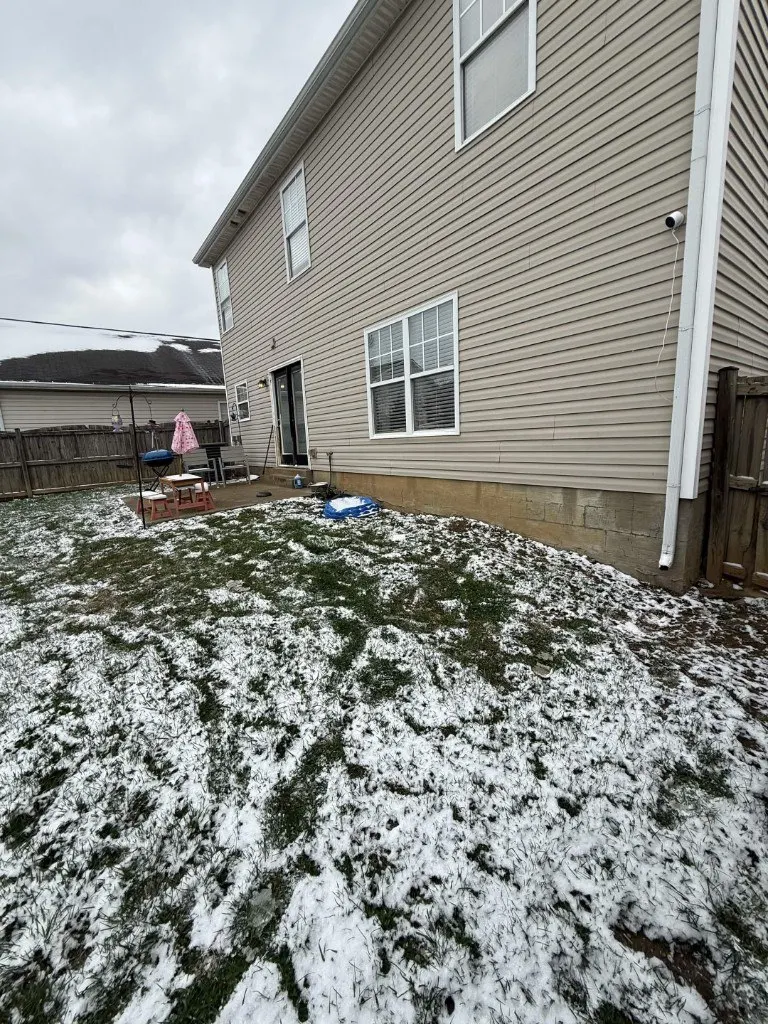 Before photo: side of home prior to outdoor living build by Big Blue Fence & Deck